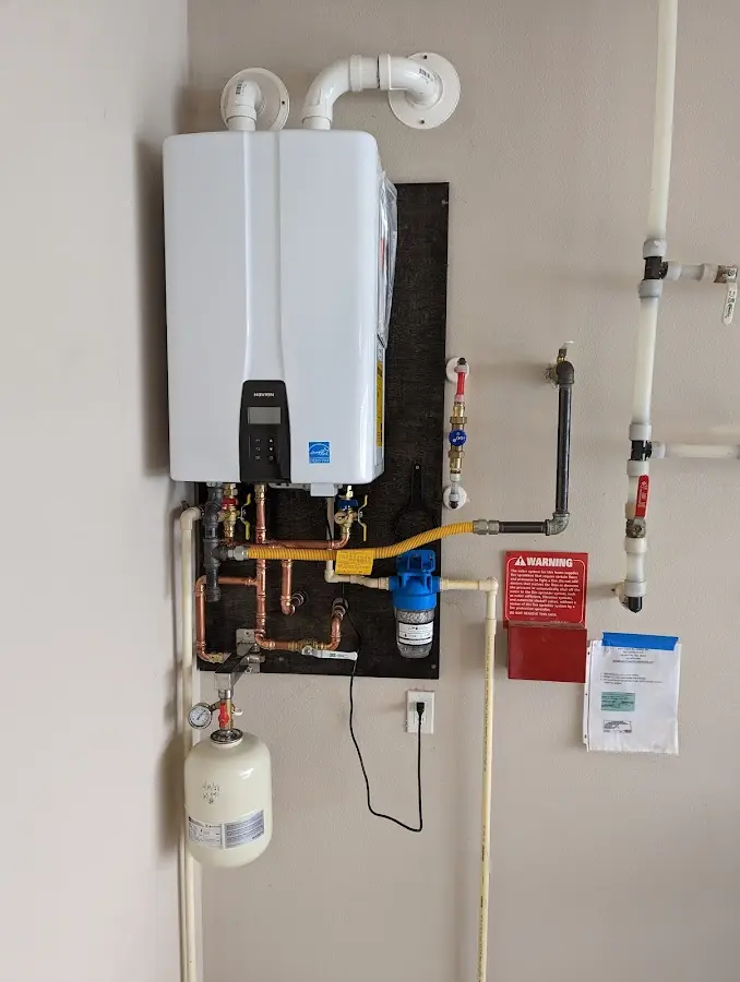 Professional plumber installing copper piping in a Broadway home